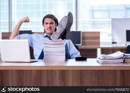 The young employee unhappy with excessive work. Young employee unhappy with excessive work