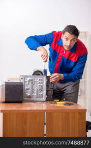 The young engineer repairing musical hi-fi system. Young engineer repairing musical hi-fi system