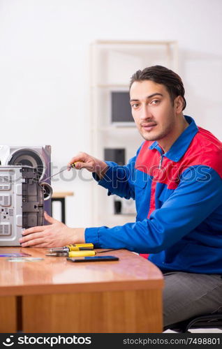 The young engineer repairing musical hi-fi system. Young engineer repairing musical hi-fi system