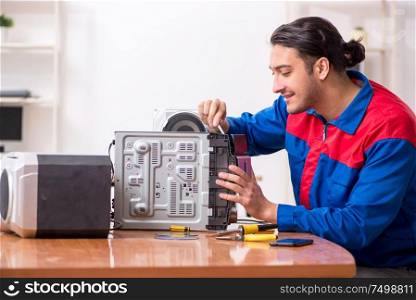 The young engineer repairing musical hi-fi system. Young engineer repairing musical hi-fi system