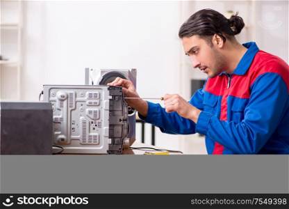 The young engineer repairing musical hi-fi system. Young engineer repairing musical hi-fi system