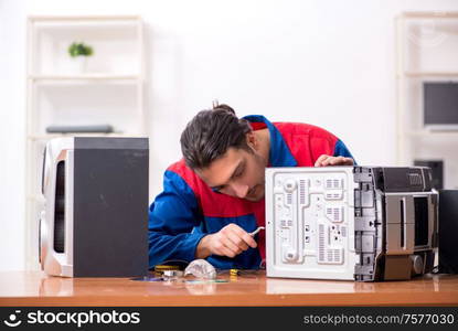 The young engineer repairing musical hi-fi system. Young engineer repairing musical hi-fi system