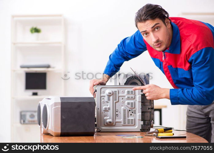 The young engineer repairing musical hi-fi system. Young engineer repairing musical hi-fi system