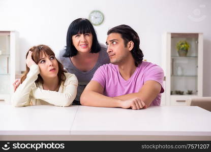 The young family and mother-in-law in family issues concept. Young family and mother-in-law in family issues concept