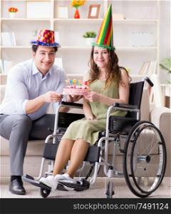 The young family celebrating birthday with disabled person. Young family celebrating birthday with disabled person