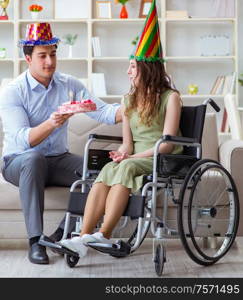 The young family celebrating birthday with disabled person. Young family celebrating birthday with disabled person