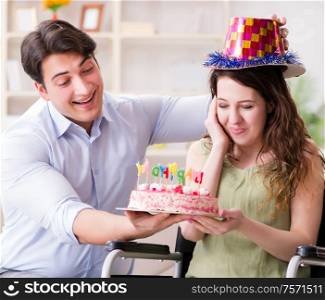 The young family celebrating birthday with disabled person. Young family celebrating birthday with disabled person