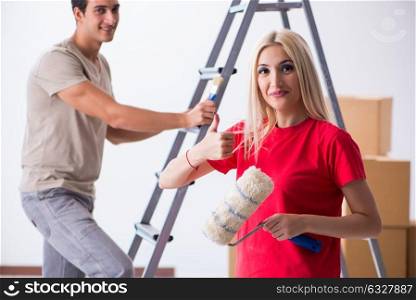 The young family doing painting job during home renovation. Young family doing painting job during home renovation