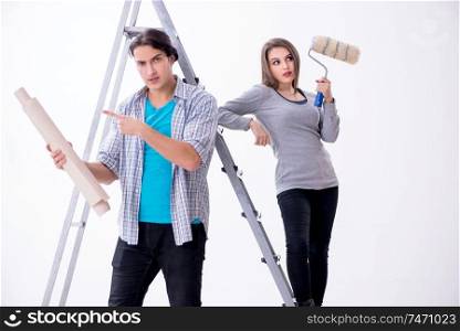 The young family doing renovation at home . Young family doing renovation at home 