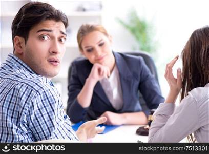 The young family filing divorce papers with lawyer. Young family filing divorce papers with lawyer
