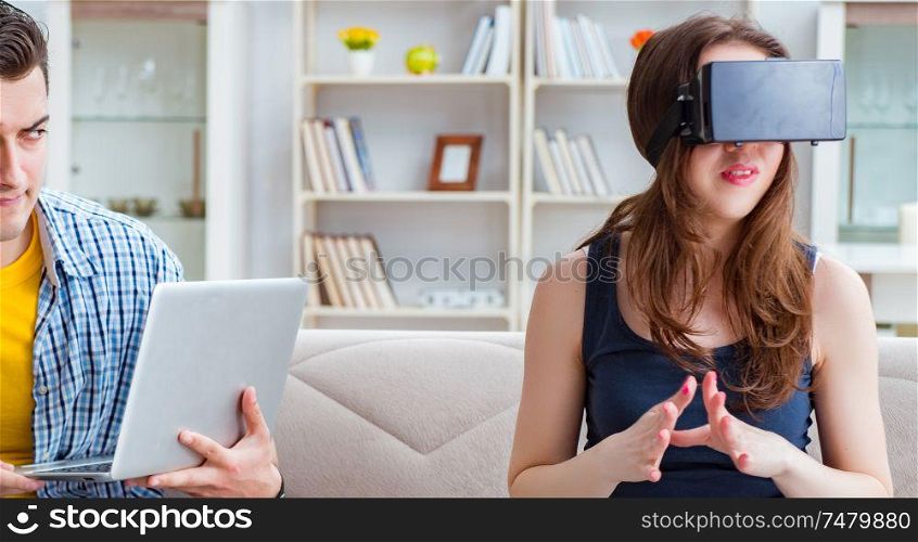 The young family playing games with virtual reality glasses. Young family playing games with virtual reality glasses