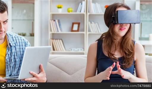 The young family playing games with virtual reality glasses. Young family playing games with virtual reality glasses