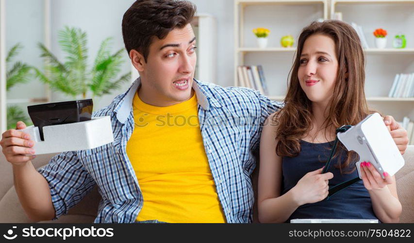 The young family playing games with virtual reality glasses. Young family playing games with virtual reality glasses