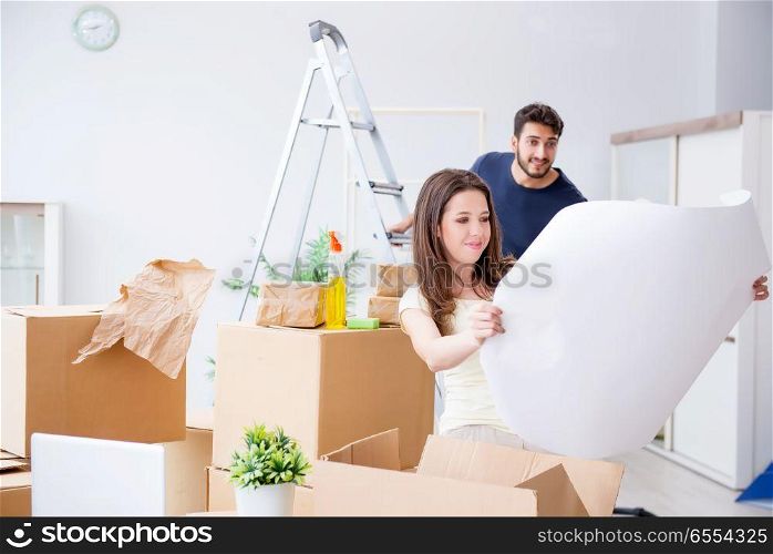 The young family unpacking at new house with boxes. Young family unpacking at new house with boxes