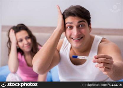 The young family with pregnancy test results. Young family with pregnancy test results