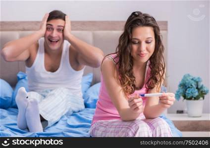 The young family with pregnancy test results. Young family with pregnancy test results