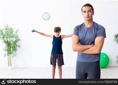 The young father and his son doing exercises. Young father and his son doing exercises