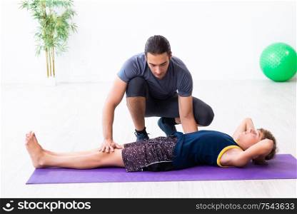 The young father and his son doing exercises. Young father and his son doing exercises