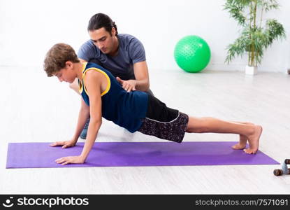 The young father and his son doing exercises. Young father and his son doing exercises