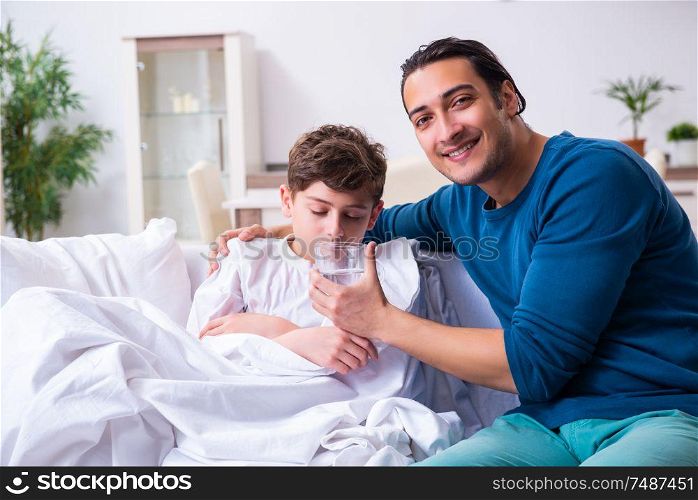 The young father caring for sick son . Young father caring for sick son
