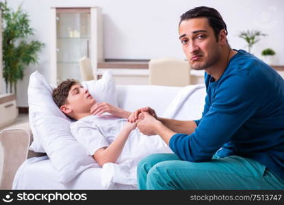 The young father caring for sick son. Young father caring for sick son