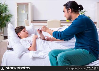 The young father caring for sick son. Young father caring for sick son