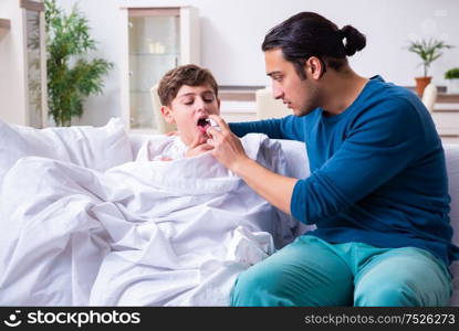 The young father caring for sick son. Young father caring for sick son