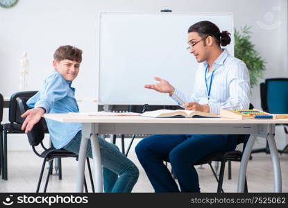 The young father helping his son to prepare for exam. Young father helping his son to prepare for exam