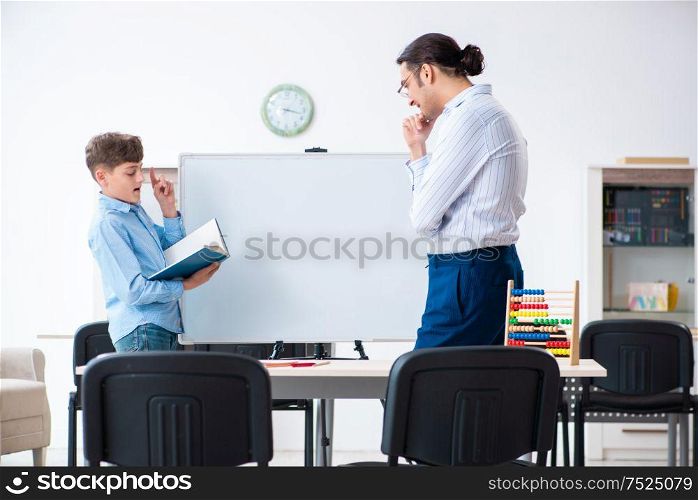 The young father helping his son to prepare for exam. Young father helping his son to prepare for exam