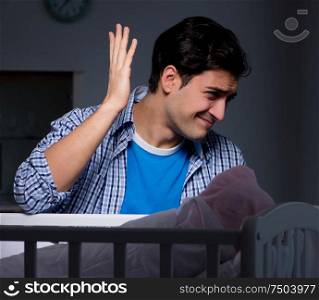 The young father under stress due to baby crying at night. Young father under stress due to baby crying at night