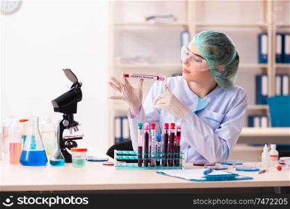 The young female chemist working in the lab . Young female chemist working in the lab 