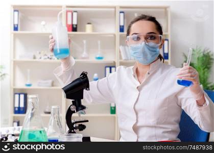 The young female chemist working in the lab . Young female chemist working in the lab
