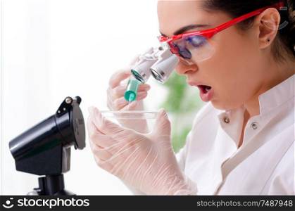 The young female chemist working in the lab. Young female chemist working in the lab