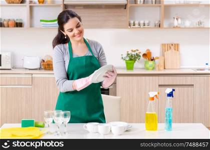 The young female contractor doing housework . Young female contractor doing housework