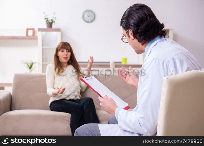 The young female patient discussing with male psychologist personal . Young female patient discussing with male psychologist personal