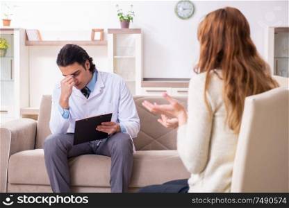 The young female patient discussing with male psychologist personal. Young female patient discussing with male psychologist personal