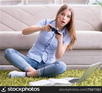 The young female student playing games at home. Young female student playing games at home