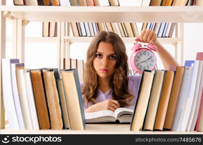 The young female student preparing for exams at library. Young female student preparing for exams at library