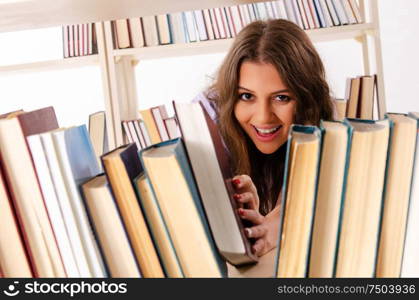 The young female student preparing for exams at library. Young female student preparing for exams at library