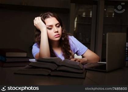 The young female student preparing for exams late at home . Young female student preparing for exams late at home