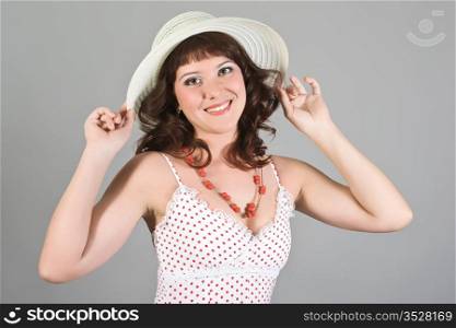 The young girl in a beautiful hat and an elegant dress
