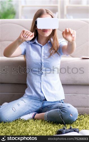 The young girl playing virtual reality games. Young girl playing virtual reality games