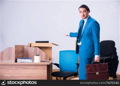 The young handsome businessman being fired from his work . Young handsome businessman being fired from his work 