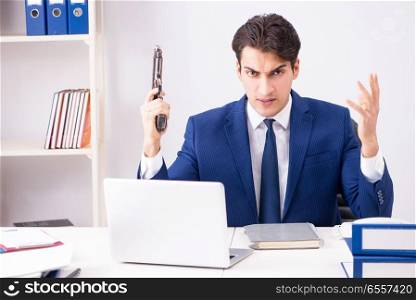 The young handsome businessman employee working in office at desk. Young handsome businessman employee working in office at desk