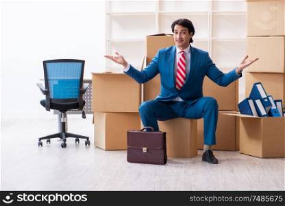 The young handsome businessman moving to new workplace. Young handsome businessman moving to new workplace