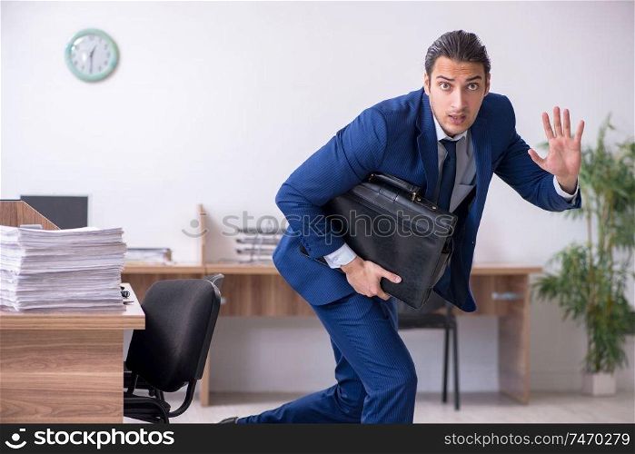 The young handsome businessman working in the office . Young handsome businessman working in the office 