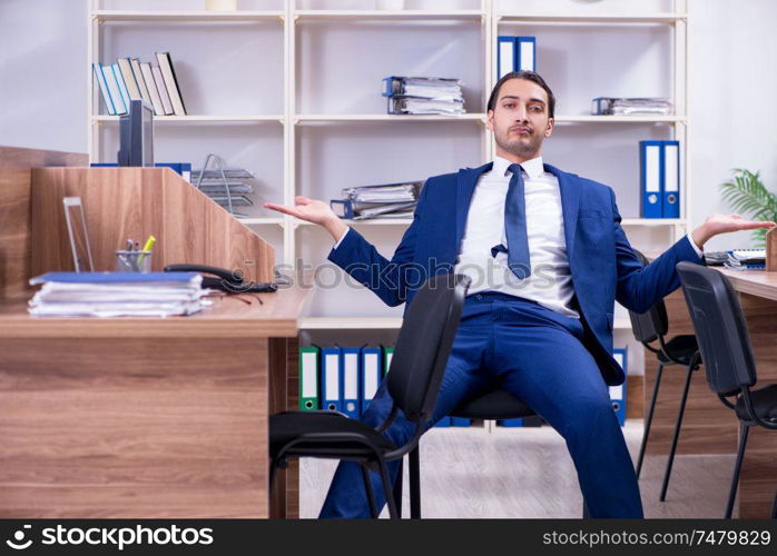 The young handsome businessman working in the office . Young handsome businessman working in the office