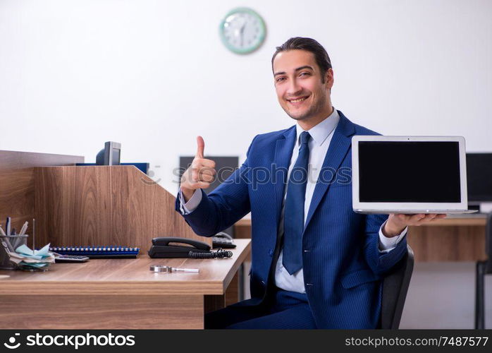 The young handsome businessman working in the office. Young handsome businessman working in the office