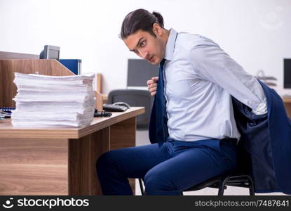 The young handsome businessman working in the office. Young handsome businessman working in the office