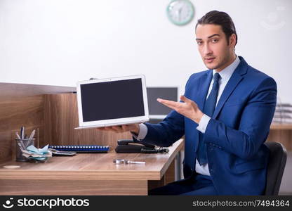 The young handsome businessman working in the office. Young handsome businessman working in the office